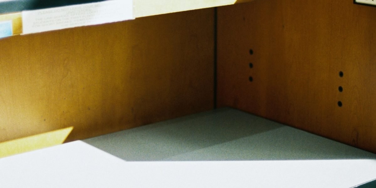 Person concentrating at a tidy desk with a laptop and notebook