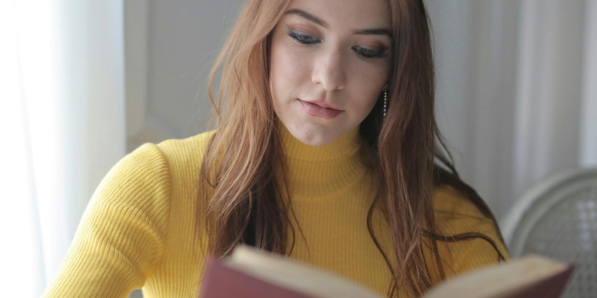 A person completely absorbed in reading a book, demonstrating deep concentration and focus.