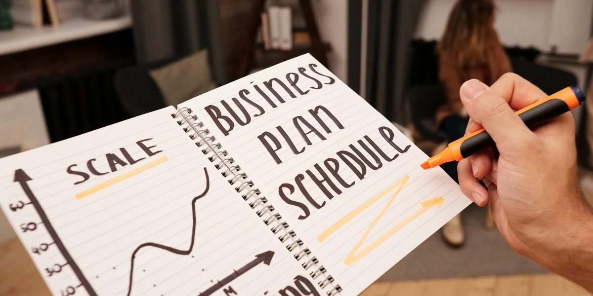 An individual thoughtfully organizing their schedule, representing the commitment to building a new daily habit.