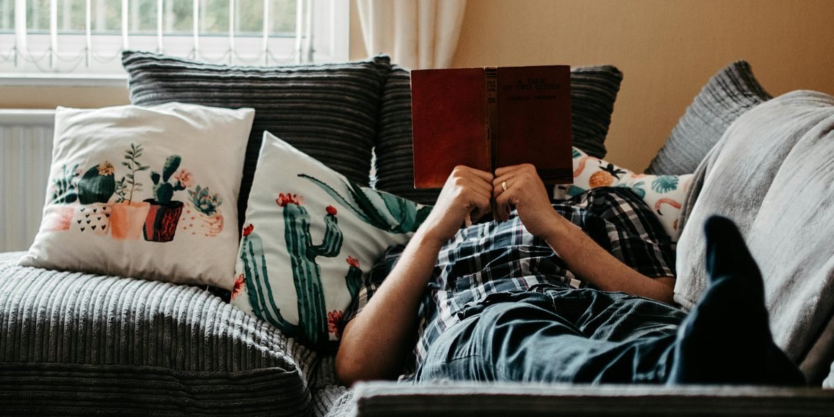 A person enjoying a moment of quiet reading, emphasizing the comfort and calm associated with a focused reading session.