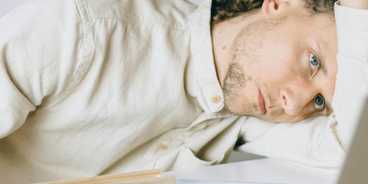 A person looking tired and drained, symbolizing the mental fatigue caused by constant digital stimulation and app overload.
