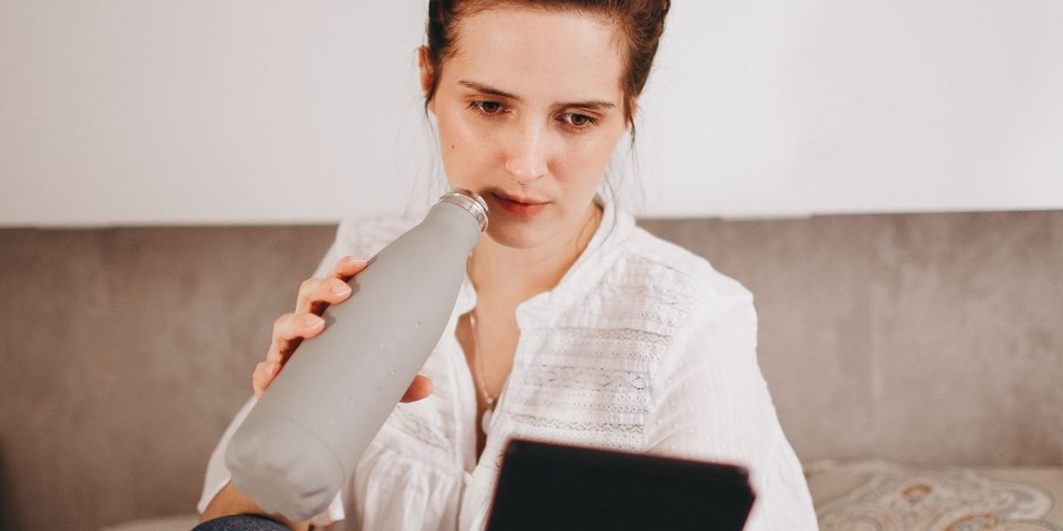 A person comfortably reading on an e-reader, benefiting from its eye-friendly display technology.