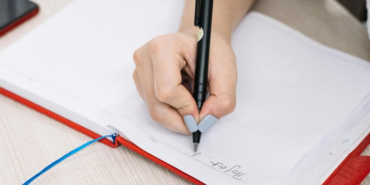 A person actively taking notes, demonstrating the 'listen-to-learn' protocol to deepen comprehension and reinforce focus.