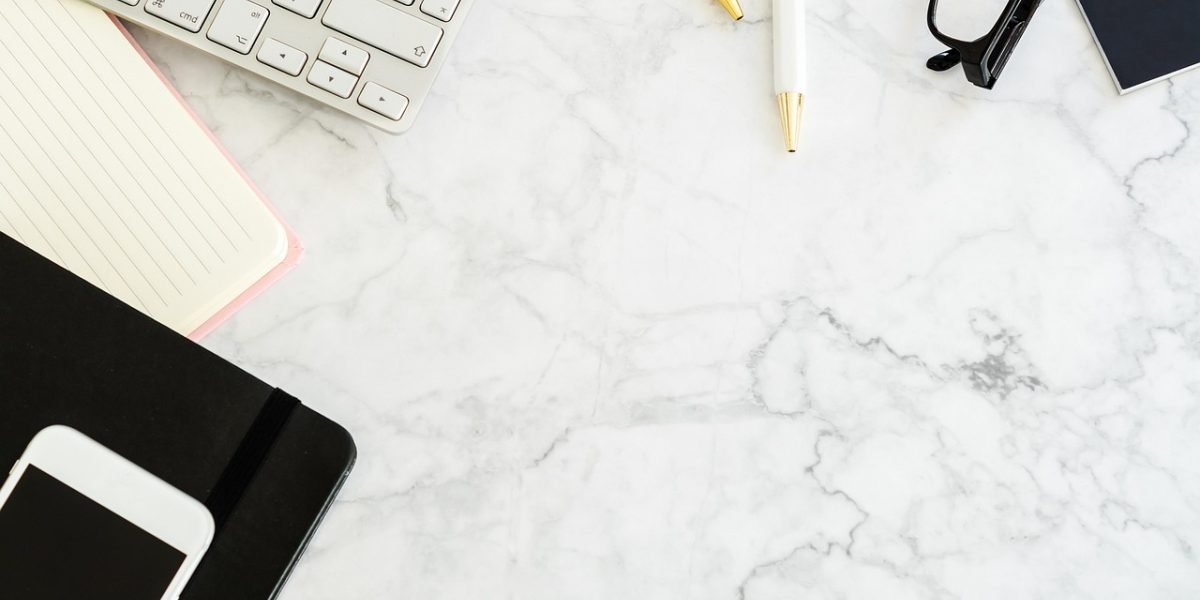 A person carefully organizes their home office or study space, creating a clean and distraction-free environment for focused learning.