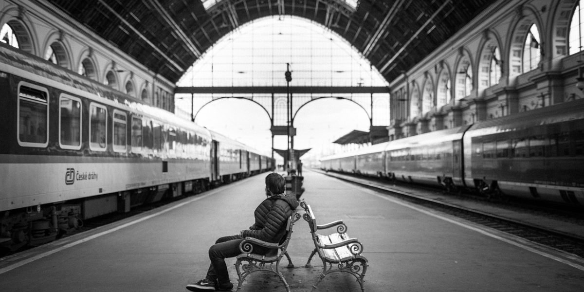 A person reading on their e-reader while commuting, showcasing the device's portability and long battery life.