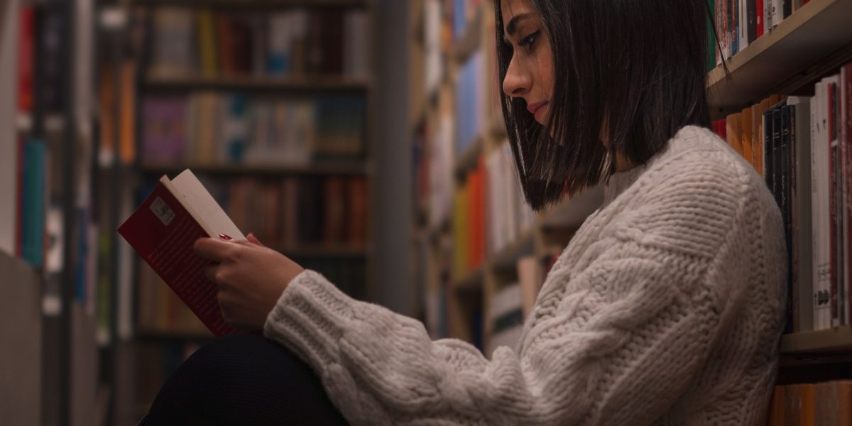 A person intently reading a book, symbolizing renewed focus away from digital distractions.