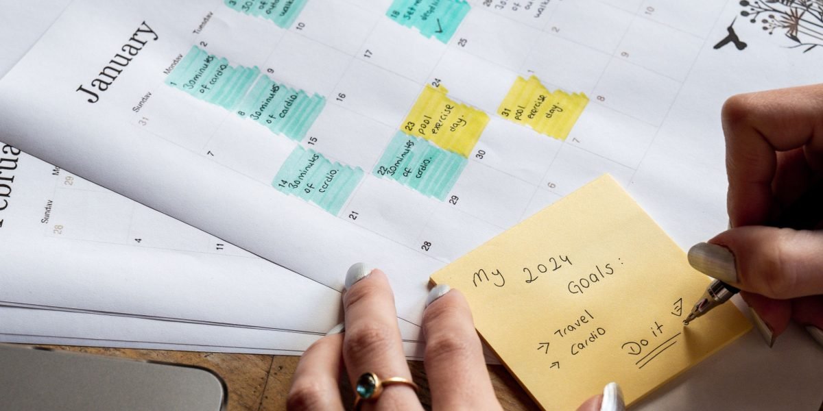 A person making notes or planning, representing the commitment and goal-setting aspect of tracking.
