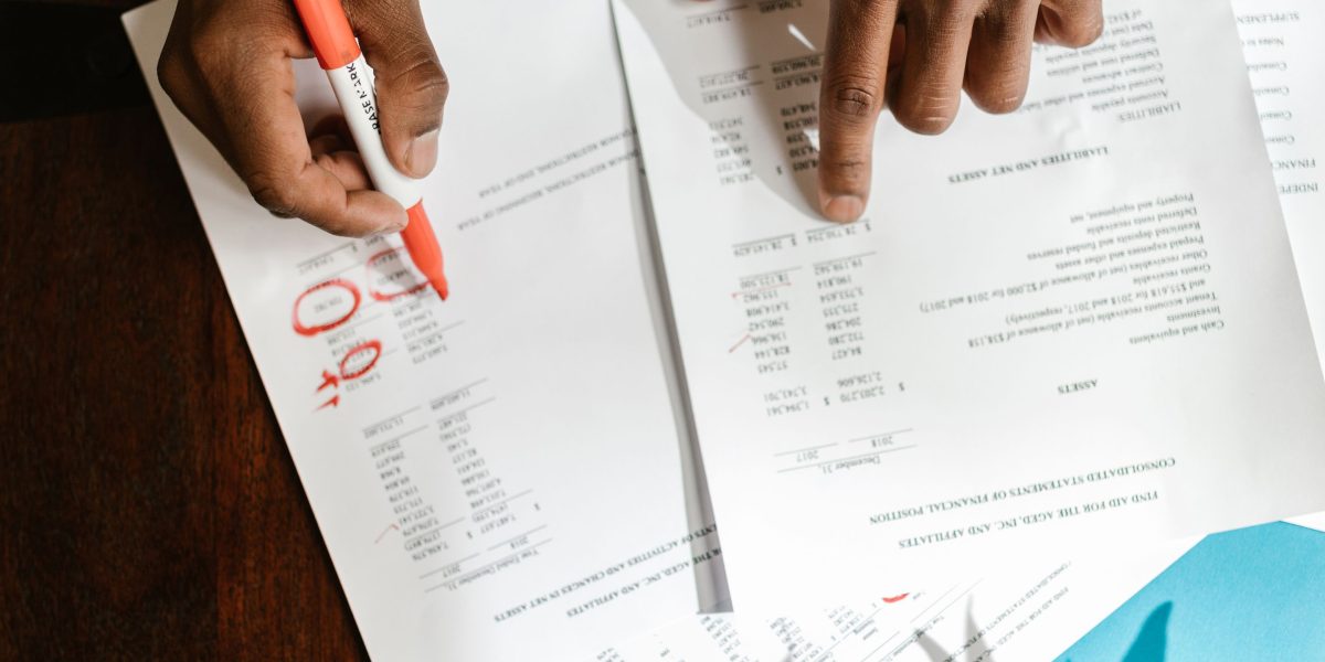 A person reviewing documents or notes, symbolizing the act of measuring progress and deep reflection.