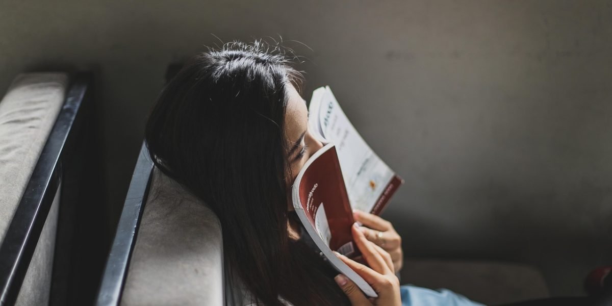 Someone arranging a cozy, quiet corner, emphasizing the importance of a distraction-free environment for reading.