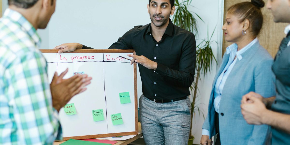 A team engaged in a focused discussion, possibly at a whiteboard or in a meeting, representing collective attention.