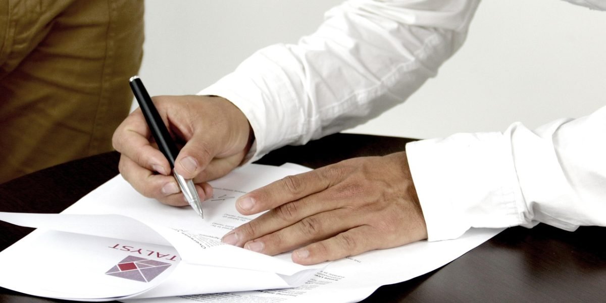 A person carefully reviewing a document with notes, symbolizing the process of identifying and correcting formatting errors.