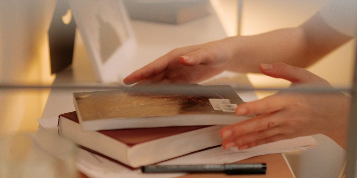 A person intentionally organizes their physical and digital space to minimize distractions for a productive study session.