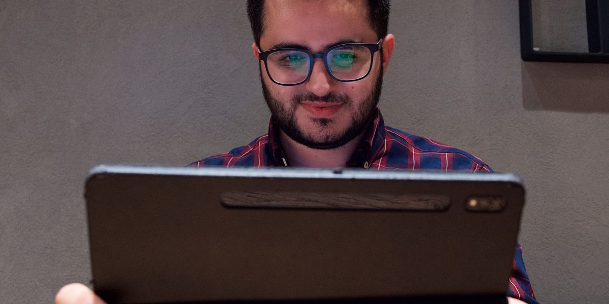 A person engrossed in reading on a mobile device, enjoying a clean and distraction-free experience.