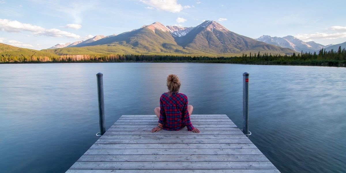 A person experiencing a sense of peace and calm, reflecting the potential positive outcome of meditation music.