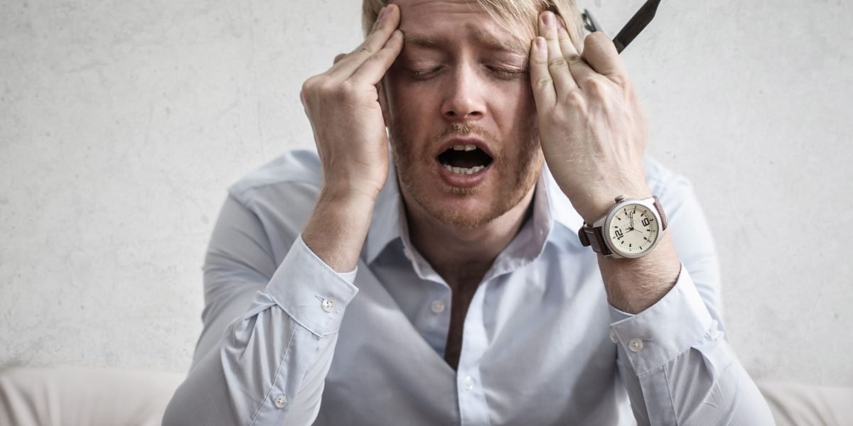 A person experiencing digital overload, reflecting the challenge of maintaining focus in a distracting world.