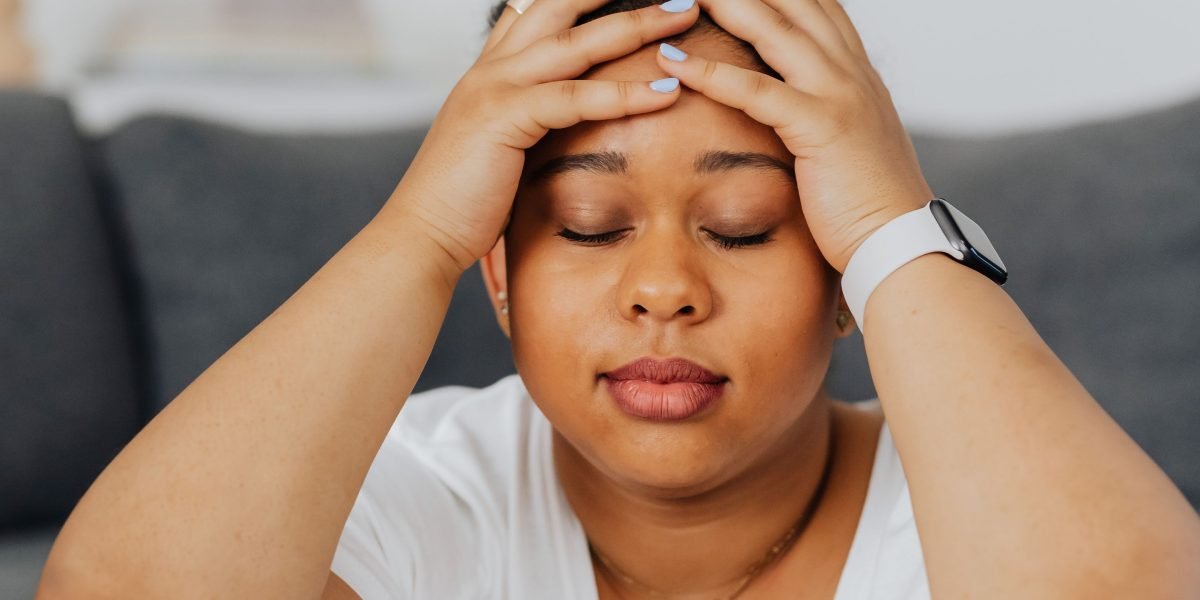A person at a desk trying to concentrate amidst distractions.