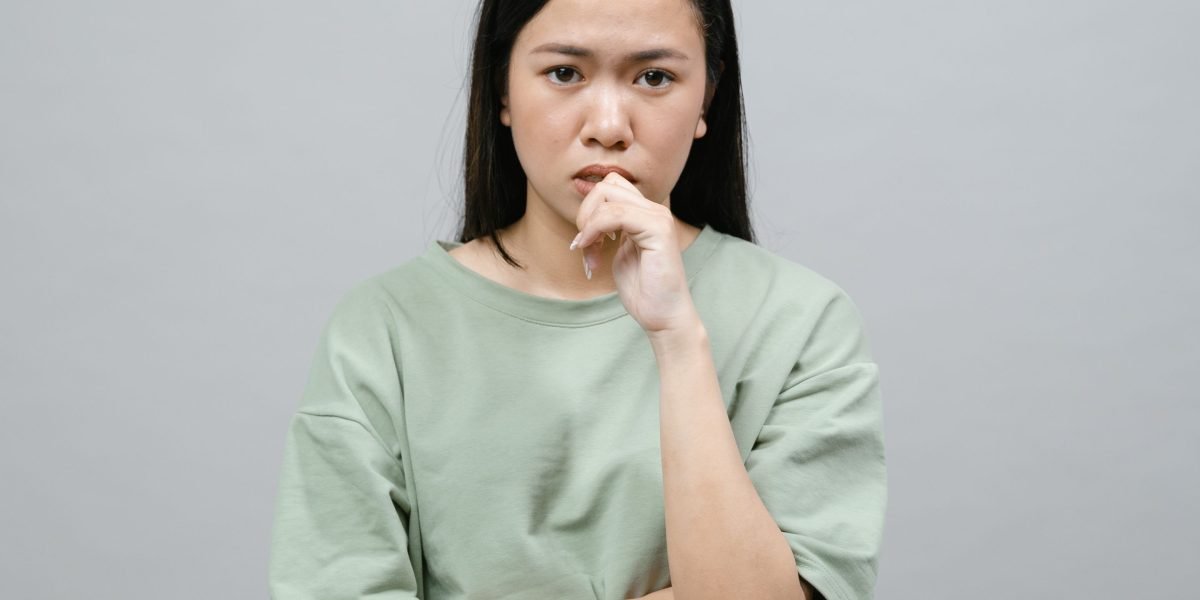 A person in deep thought, reflecting on their health concerns or symptoms that may lead to a brain scan.