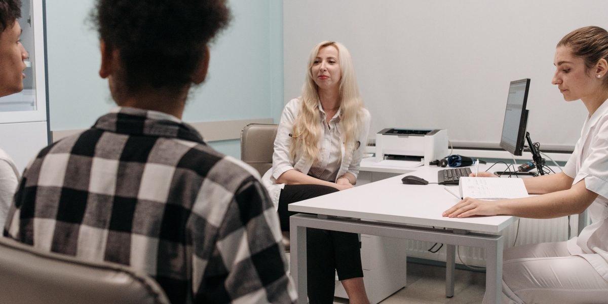 A patient discussing the upcoming brain CT scan procedure with a medical professional, seeking reassurance.