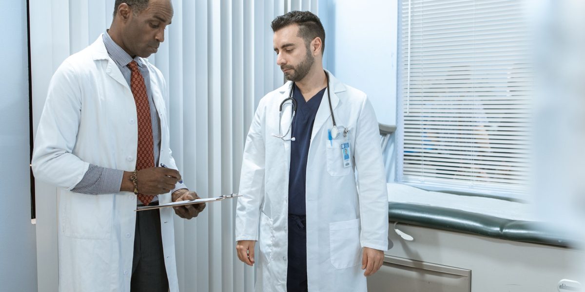 A team of medical professionals collaborating and discussing a patient's recovery and rehabilitation plan, potentially reviewing scans.
