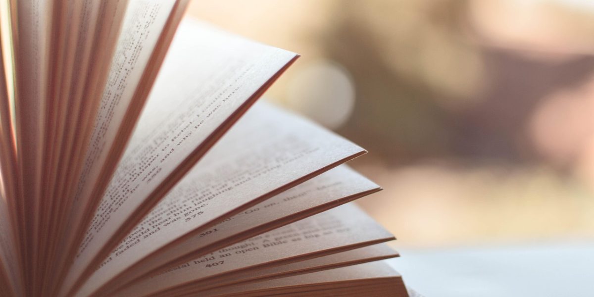A person relaxed and contented while enjoying their reading experience.